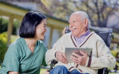 a younger and older person are talking and smiling at each other